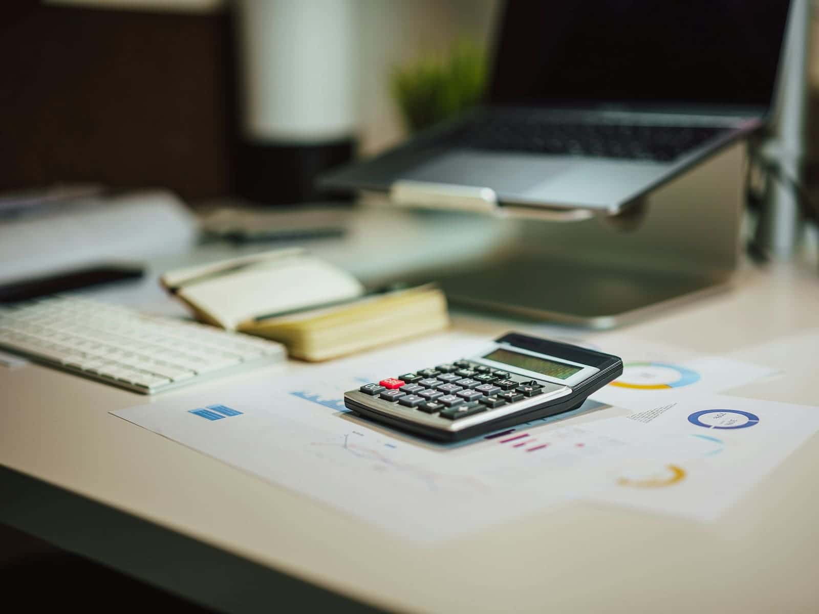Business documents and a laptop on a desk