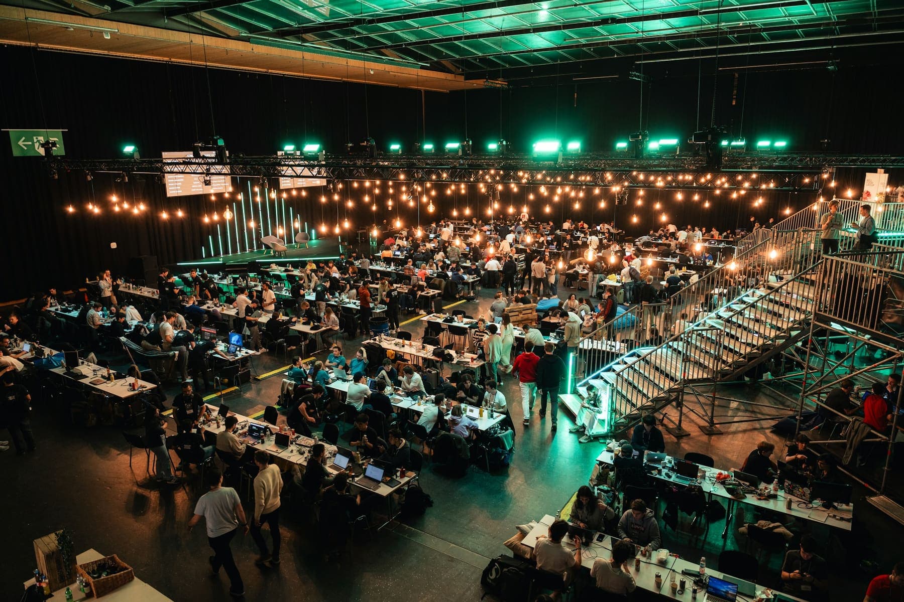 Hackathon participants working in teams at a large event